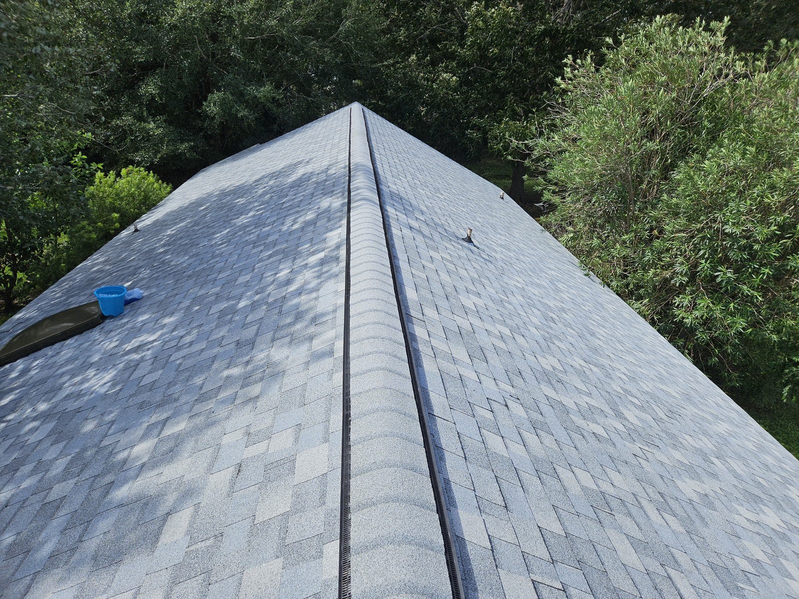 Close-up of new architectural shingles and a ridge vent